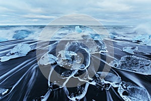 Jokulsarlon glacier lagoon, fantastic sunset on the black beach, Iceland.