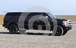 Jokulsarlon, Iceland - 23. June 2022: Side view of a huge black Ford F350 supertruck on a parking area