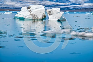 Jokulsarlon lake with icebergs on a sunny day, Iceland. Long exposure view with moving blocks of ice