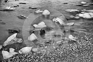 Jokulsarlon lake with icebergs on a sunny day, Iceland. Long exposure view with moving blocks of ice