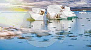 Jokulsarlon lake with icebergs on a sunny day, Iceland. Long exposure view with moving blocks of ice