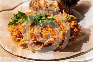 Jollof Rice close up garnished with pieces of roasted chicken