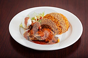 Jollof rice with fish and salad