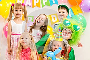 Jolly kids group and clown on birthday party