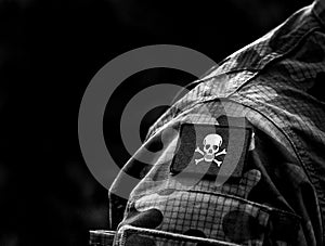 Jolly Roger pirate flag on military uniform. A skull and crossbones or death`s head a symbol of death