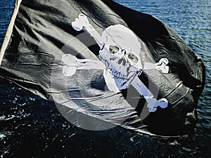 Jolly Rogers pirate flag flying from a sailing boat