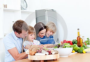 Jolly young family cooking together