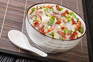 Jook congee is a type of rice porridge that`s popular in many parts of Asia close-up in a bowl. Horizontal