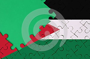 Jordan flag is depicted on a completed jigsaw puzzle with free green copy space on the left side