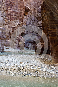 Jordan. Wadi Al Mujib Canyon in Wadi Mujib Nature Biosphere Reserve. Sheer cliffs of enormous height are polished by water