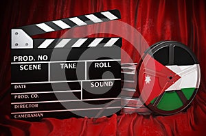 Jordanian cinematography, film industry, cinema in Jordan. Clapperboard with and film reels on the red fabric, 3D rendering