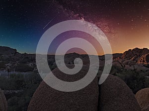 Joshua Tree National Park in California. Rocks on the dessert at night with milky way view and stars