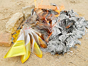 Joss papers burning at cemetery