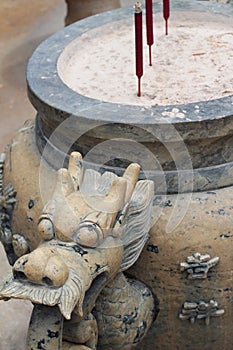 Joss stick pot with dragon sculpture in the temple