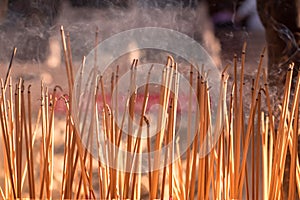 Joss sticks burning at a vintage Buddhist temple courtyard as offering during Chinese New Year in temple