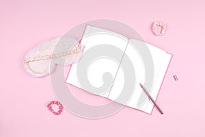 Journal with cute white fluffy sleep mask and pink accessories