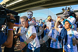 Journalist interviewing sport fans from Argentina.