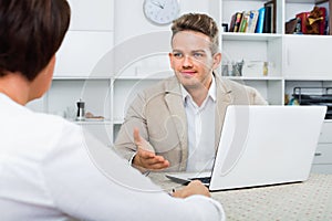 Journalist with laptop interviews the elderly wealthy woman