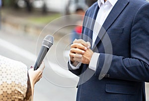 Journalist making media interview with unrecognizable person. Vox populi concept