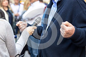 Journalist making media or vox pop interview with unrecognizable person