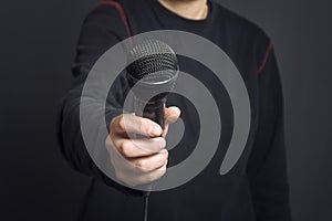 Journalist making speech with microphone and hand gesturing concept for interview.