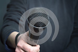 Journalist making speech with microphone and hand gesturing concept for interview.