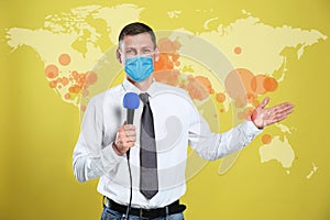 Journalist with medical mask presenting news during coronavirus. World map demonstrating spread of disease