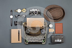 Journalist or private detective workplace - typewriter, camera, hat, recorder and other stuff