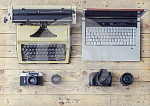 Journalistic equipment: typewriter, camera, laptop