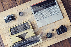 Journalistic equipment: typewriter, laptop, camera and lenses