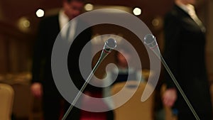 Journalists gather in the conference room for press conference. View from the tribune through the microphones.