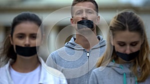 Journalists having taped mouth, violation of speech freedom, corruption bribery photo