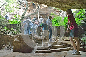 Journey of man is symbolized as tourists walk out of caves at Cradle of Humankind, a World Heritage Site in Gauteng Province