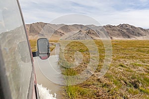 Journey of river on SUV car. Mongolia - Altai. photo made from inside car