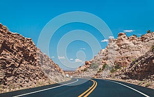 Stone desert in the USA. A picturesque road in the lifeless red rocks of Arizona