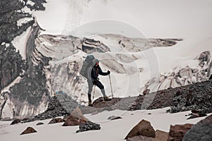 Journeyman with full climbing equipment stands on mountain