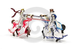 Joust of toy medieval knights. Isolated on white background