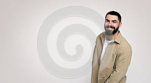 A jovial man with a beard and a wide smile leans slightly towards the camera