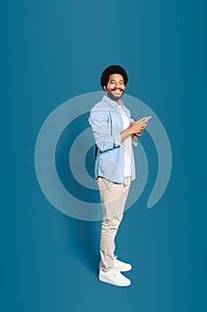 A jovial young man holding a phone