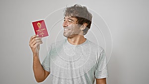 Jovial young man proudly flaunting his norwegian passport, basking in pure joy and confidence, isolated on a white background