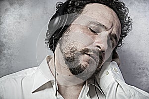 Joy, listening and enjoying music with headphones, man in white