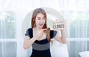 Women and shop closing signs Concept of closing and canceling business photo