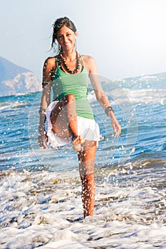 Joy summer. Girl playing on the seashore. Sea and holidays.