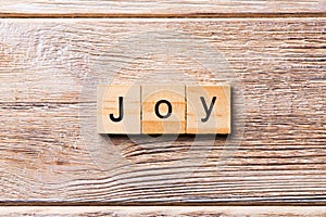 Joy word written on wood block. Joy text on wooden table for your desing, concept