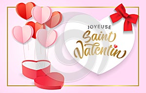 Joyeuse Saint Valentin French calligraphy with heart shaped gift box and paper hearts photo