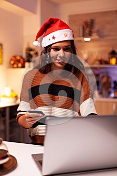 Joyful adult doing online shopping for christmas