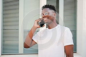 Joyful African american college student man laughing having a funny conversation. Portrait of a young guy talking using