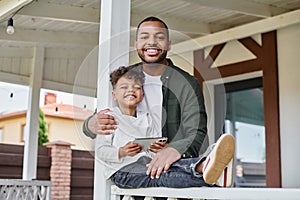 joyful african american father hugging son