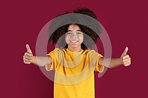 Joyful african american girl showing thumb ups, isolated