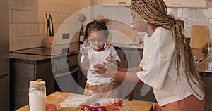 Joyful African American mother And Little Daughter Clapping Hands Having Fun